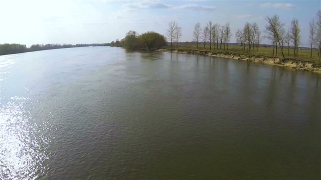Flight over river water at low height.  Aerial
