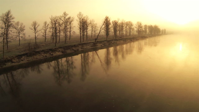 Morning quiet river in orange tones.  Aerial  rear view