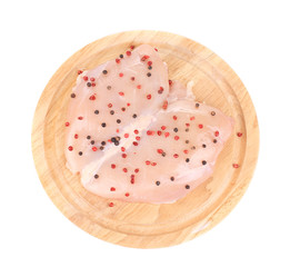 Raw chicken breast and peppers on the wooden board