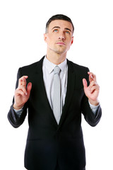 Businessman making a wish isolated on white background