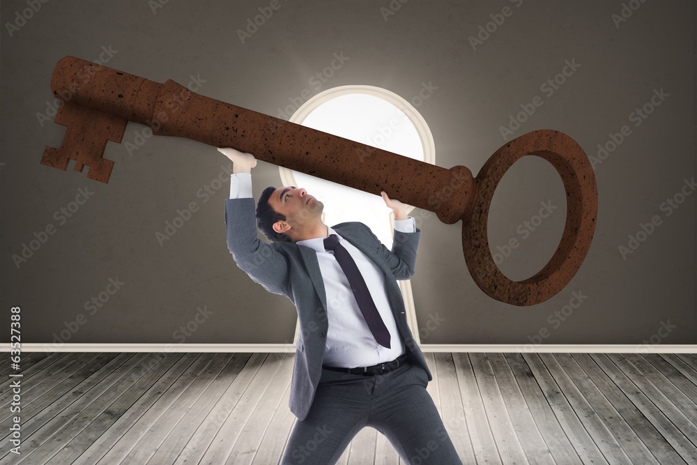 Poster Composite image of unsmiling businessman carrying large key