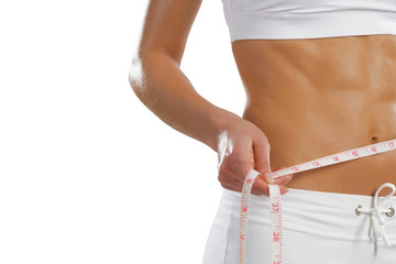 young athletic woman measuring waist