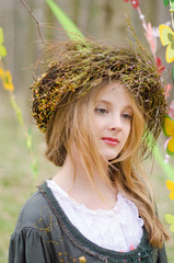 Close up portrait of a pensive girl in a folk   circlet of flowe