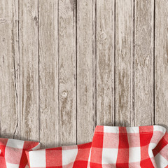 Fototapeta na wymiar old wooden table with red picnic tablecloth background