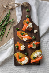 appetizer with salmon,baked potatoes and a cottage cheese