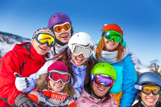 Seven smiling friends wearing goggles