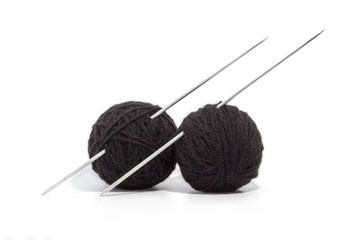 balls of yarn and knitting needles