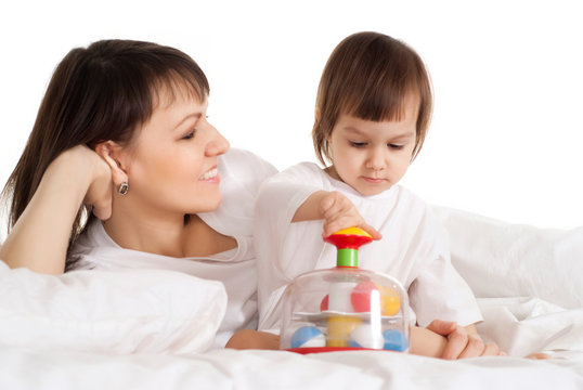 Mother with her daughter playing with a toy
