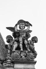 Fototapeta premium Guarding baby angel statue with wings, Paris, France