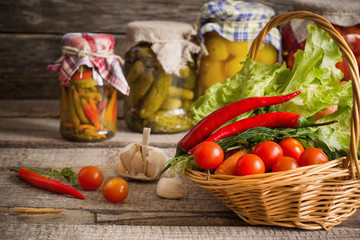 Preserved  and fresh vegetables on wooden background
