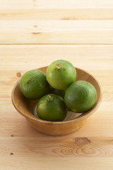 many asian lemon in wooden cup on wooden background
