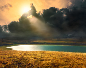 Mountain lake at sunset  before the storm