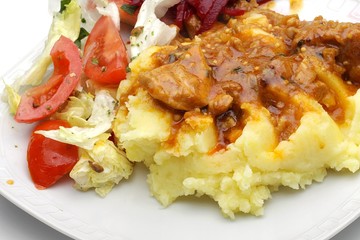 stew sauce with potatoes and raw vegetables