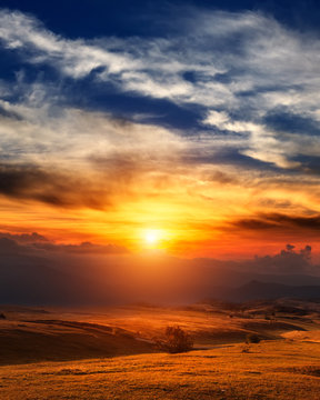 Fototapeta Mountain sunset with beautiful cloudscape