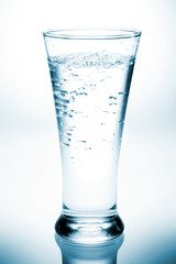 Glass with water on white background