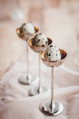 Quail eggs in elegant vintage eggcups. 