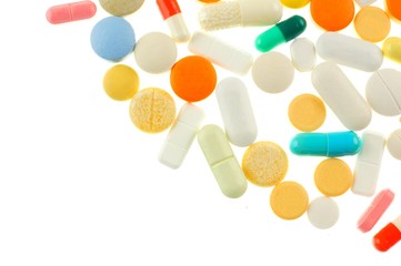 Corner border of assorted medications isolated on white