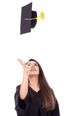 Beautiful female student throws up his graduation cap in celebra