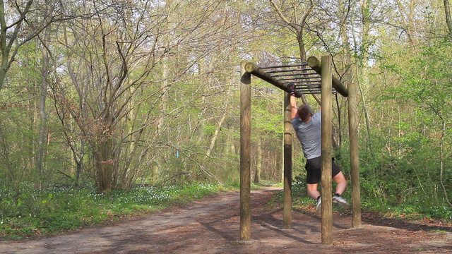 Young man working out in the forrest 