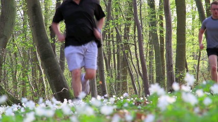 Father and Son running in the forest 