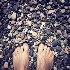 Tuinposter feet on the rocks © nito