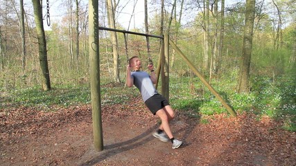 Young man working out in the forrest 