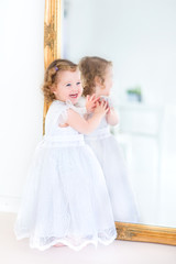 Beautiful toddler girl in a white dress