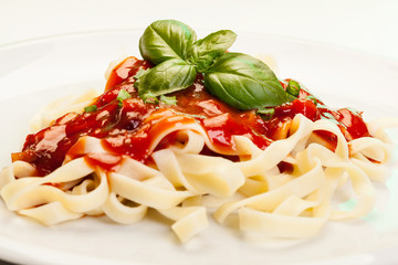 Pasta fettuccine with tomato sauce and basil