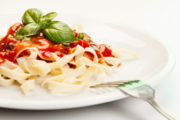 Pasta fettuccine with tomato sauce and basil