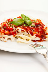 Pasta fettuccine with tomato sauce and basil