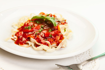 Pasta fettuccine with tomato sauce and basil