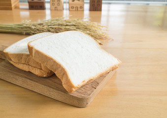 Sliced white bread on the chopping board (Space for text)