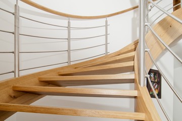 Curved wooden staircase with stainless steel elements - obrazy, fototapety, plakaty