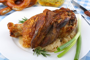 Grilled pork hock with sauerkraut, pretzels, beer