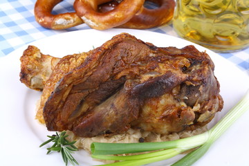 Grilled pork hock with sauerkraut, pretzels, beer