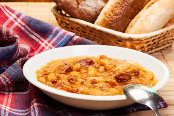 Beans with tomato sauce, bacon and sausage