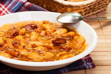 Beans with tomato sauce, bacon and sausage