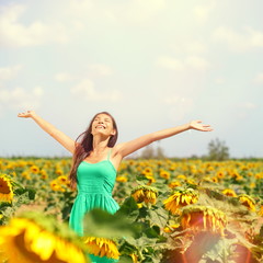 Naklejka na ściany i meble Woman summer girl happy in sunflower flower field