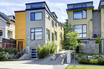 Fototapeta na wymiar Yellow residential building with siding trim