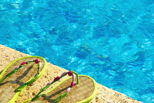 Two Flip Flops On The Platform Beside Swimming Pool