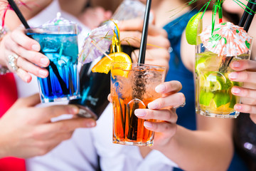 Cocktailgläser an Leuten in Bar beim Feiern