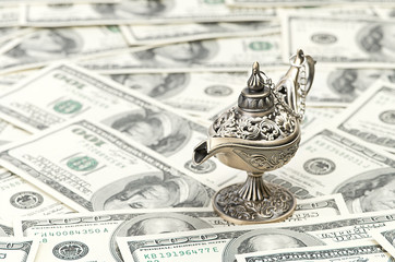 aladdin lamp on dollar background