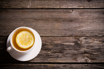 Cup of tea with lemon on the wooden table