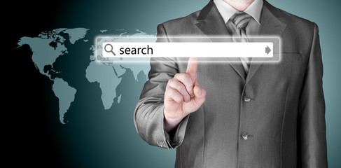 Businessman pushing virtual search bar
