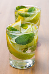 Cold fresh lemonade with lemon, lime and mint