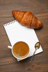 cup of espresso, croissant and notepads, photo concept