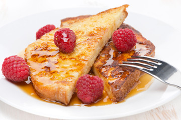 French toast with raspberries and honey, close-up