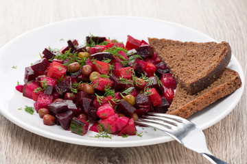 russian beetroot  salad with bread - vinaigrette, close-up