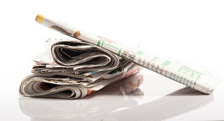 Various newspapers over white background