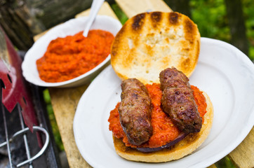 Cevapcici with ajvar in the grilled roll